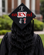 Load image into Gallery viewer, Teekajame Creations nursing graduation cap topper featuring I eaRNed It text on a black background