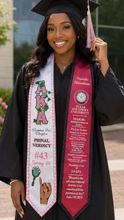 Load image into Gallery viewer, A smiling graduate wearing a black cap and gown with a pink and white sash. The sash features the text 'AKA' and 'PUNAL VERDICT #43 Spring 26' with a hand graphic, and the cap has a pink tassel.
